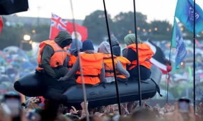 Banksy claims migrant boat artwork in crowd at Glastonbury